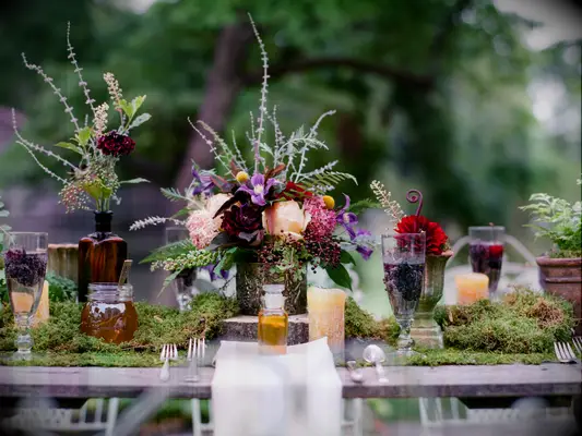 Outdoor wedding reception with moss table runner