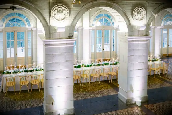 Wedding reception with long table and white uplighting 