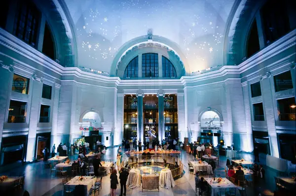 Blue celestial uplighting in large wedding reception space