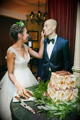 Bride and groom tasting wedding cake