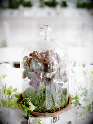 unique fall wedding centerpiece with moss and burgundy leaves in glass bell jar
