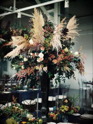 Tall fall wedding centerpiece with black vase and pampas grass
