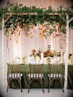 rustic fall wedding centerpiece with greenery on white birch branches