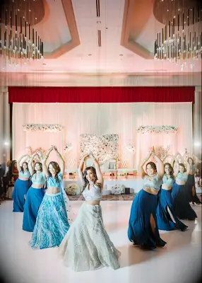 Bride and bridesmaids dancing at Indian wedding