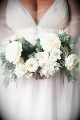 Wintry Bridal Bouquet With White Flowers and Pine and Cedar Greenery