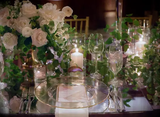 Place Setting with Greenery, Candles and Glass Dinnerware