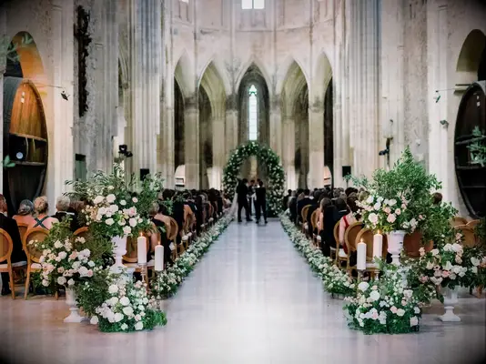 Luxurious Ceremony Aisle in Historic French Venue, White Flowers and Greenery, Verdant Arch
