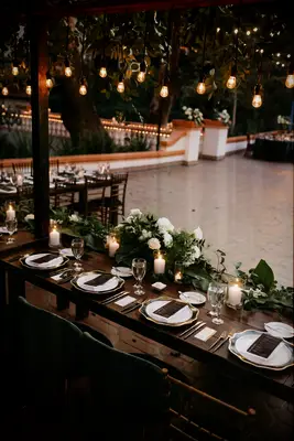 Long Head Table With Hanging Installation of Edison Lights, Hanging Greenery and Floral Runners