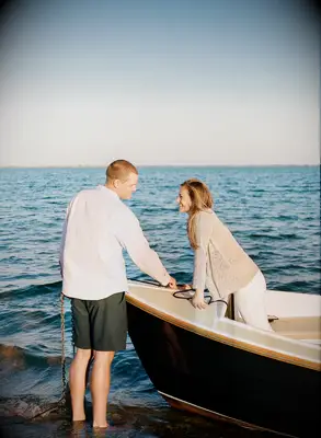 Couple poses on a boat. 