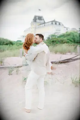 Couple shares a sweet kiss on a beautiful beach. 
