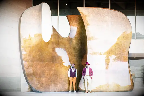 Couple poses in front of art installation