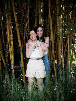 Hugging engagement photoshoot among bamboo