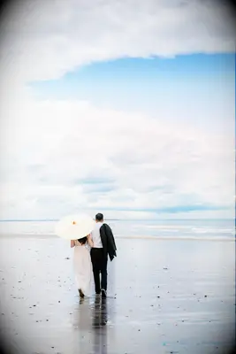 Beach engagement photoshoot with sunny parasol