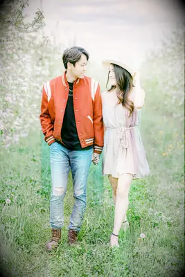 Couple walking through tree grove holding hands