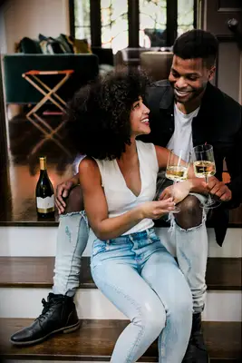 At-home engagement photo with white wine