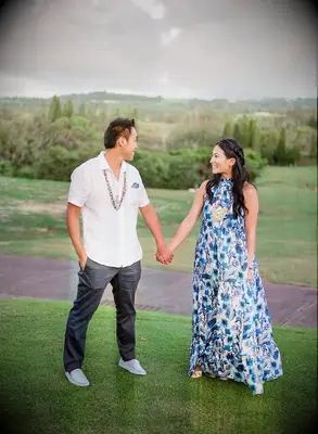 Couple holding hands on hill in Hawaii