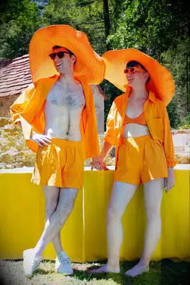 Couple wearing matching bright orange summer outfits