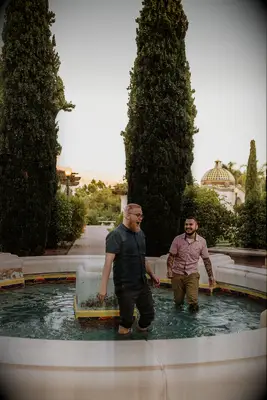 Couple jumping in fountain during San Diego engagement session