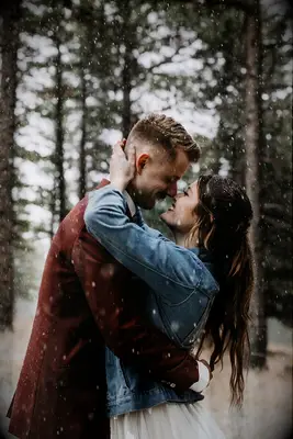 A kiss in the snow engagement photo