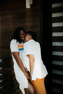 Couple snuggling during relaxed engagement photo shoot