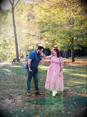 A kiss on the hand outdoor engagement photo idea