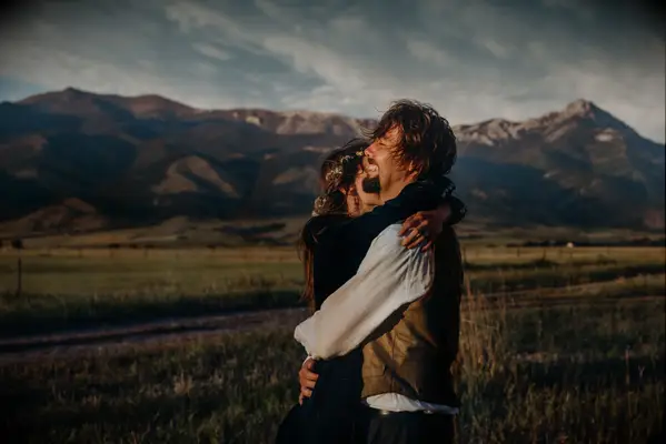 Windy engagement photo idea in the mountains