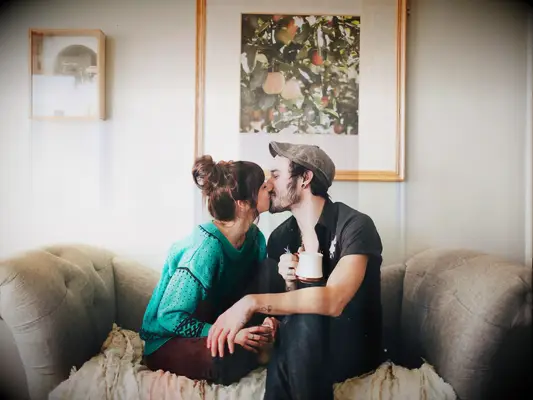 Couple kissing on sofa