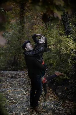 Couple poses like explorers in the woods at their engagement shoot. 