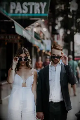 Couple poses with funky sunglasses. 