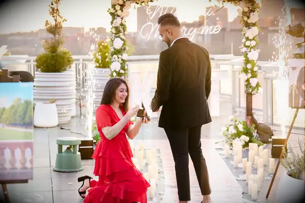 Woman proposing to boyfriend on rooftop