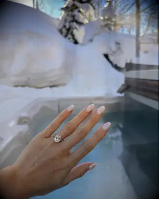 Engagement ring selfie in front of a snowy mountain
