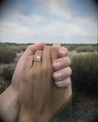 Engagement photo of couple holding hands