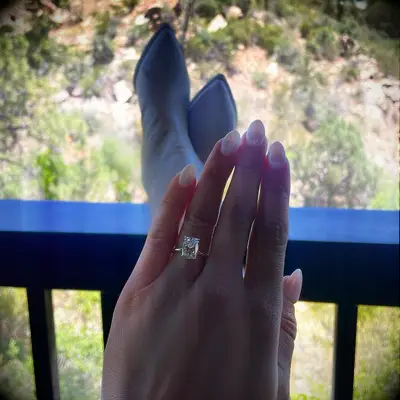 Bride taking ring selfie with engagement ring