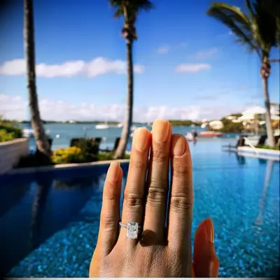 Engagement ring selfie in front of pool
