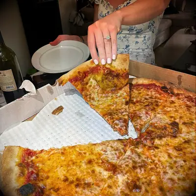Engagement ring selfie with a pizza pie