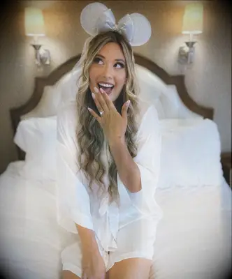 Disney bride showing engagement ring wearing mickey ears