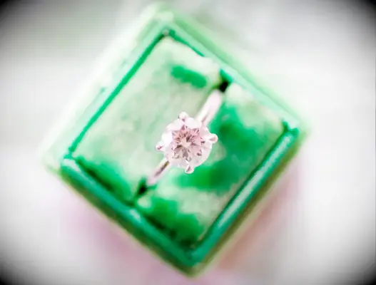 how to tell if a diamond ring is fake at home tests with a round-cut diamond ring in a green velvet ring box