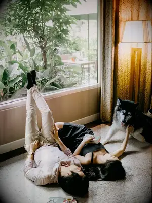 Couple lying on floor with husky dog