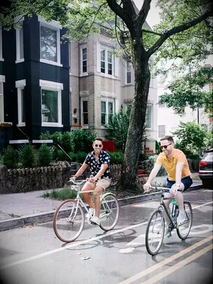 Two men cycling alongside each other