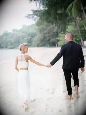 Couple holding hands on the beach