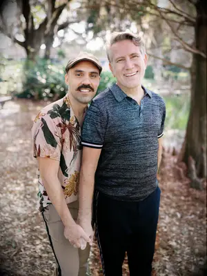 Two gents smile for the camera in this adorable engagement photo