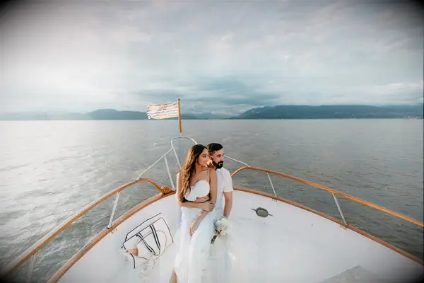A couple stare out over the water in the yacht engagement photoshoot