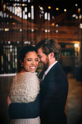 A man and woman share an intimate moment in the evening for their fall engagement photoshoot