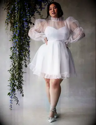 Short plus sized wedding dress by ELOQUII. 