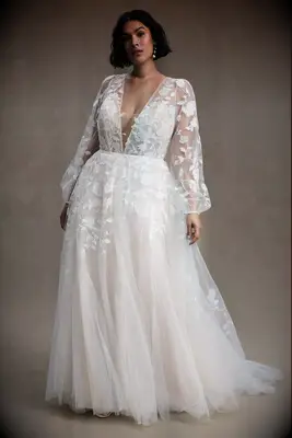 Long sleeved plus size wedding dress by Anthropologie. 