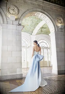 Wedding dress with a large pastel blue bow, best pastel weddings dresses 2023. 