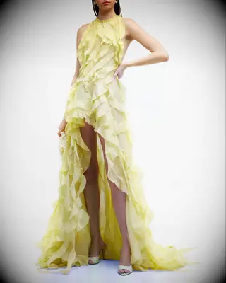 Yellow ruffle gown with a halter neckline, best pastel wedding dresses 2023. 