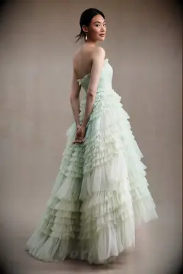 Strapless tiered pastel green wedding dress by Mac Duggal. 