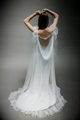 Pearl-adorned wedding cape with ruffled edges