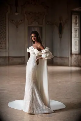 Crystal-embellished wedding gown with oversized bow cape